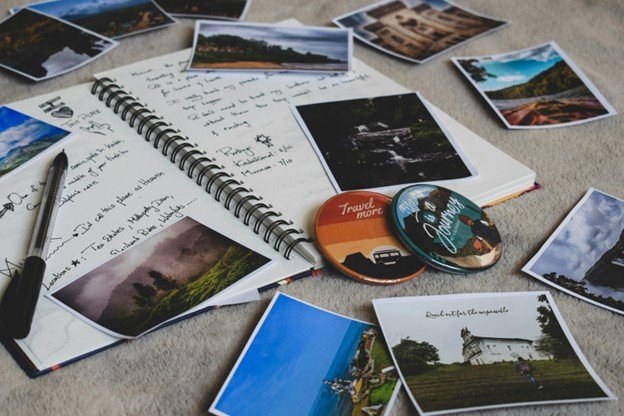 A scrapbook with pictures, badges and postcards